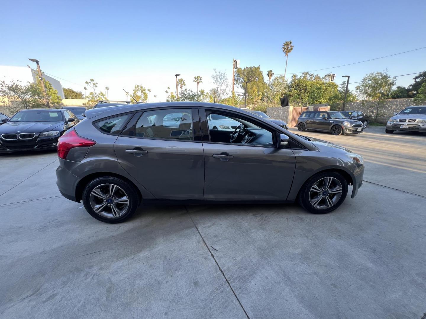 2014 Gray /Balck Ford Focus SE Hatch (1FADP3K21EL) with an 2.0L L4 DOHC 16V engine, Automatic transmission, located at 30 S. Berkeley Avenue, Pasadena, CA, 91107, (626) 248-7567, 34.145447, -118.109398 - Microsoft Sync! Moon-roof! This 2014 Ford Focus SE Hatch looks and drives good. Bad credit? We can help! We are the bank. - Photo#11