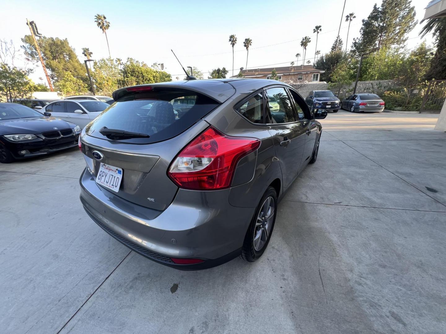 2014 Gray /Balck Ford Focus SE Hatch (1FADP3K21EL) with an 2.0L L4 DOHC 16V engine, Automatic transmission, located at 30 S. Berkeley Avenue, Pasadena, CA, 91107, (626) 248-7567, 34.145447, -118.109398 - Microsoft Sync! Moon-roof! This 2014 Ford Focus SE Hatch looks and drives good. Bad credit? We can help! We are the bank. - Photo#13