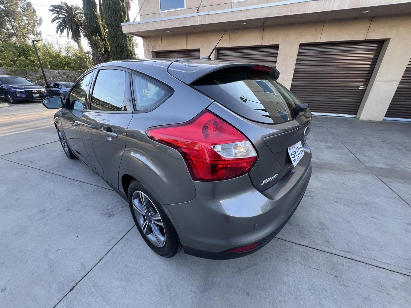 2014 Gray /Balck Ford Focus SE Hatch (1FADP3K21EL) with an 2.0L L4 DOHC 16V engine, Automatic transmission, located at 30 S. Berkeley Avenue, Pasadena, CA, 91107, (626) 248-7567, 34.145447, -118.109398 - Microsoft Sync! Moon-roof! This 2014 Ford Focus SE Hatch looks and drives good. Bad credit? We can help! We are the bank. - Photo#14