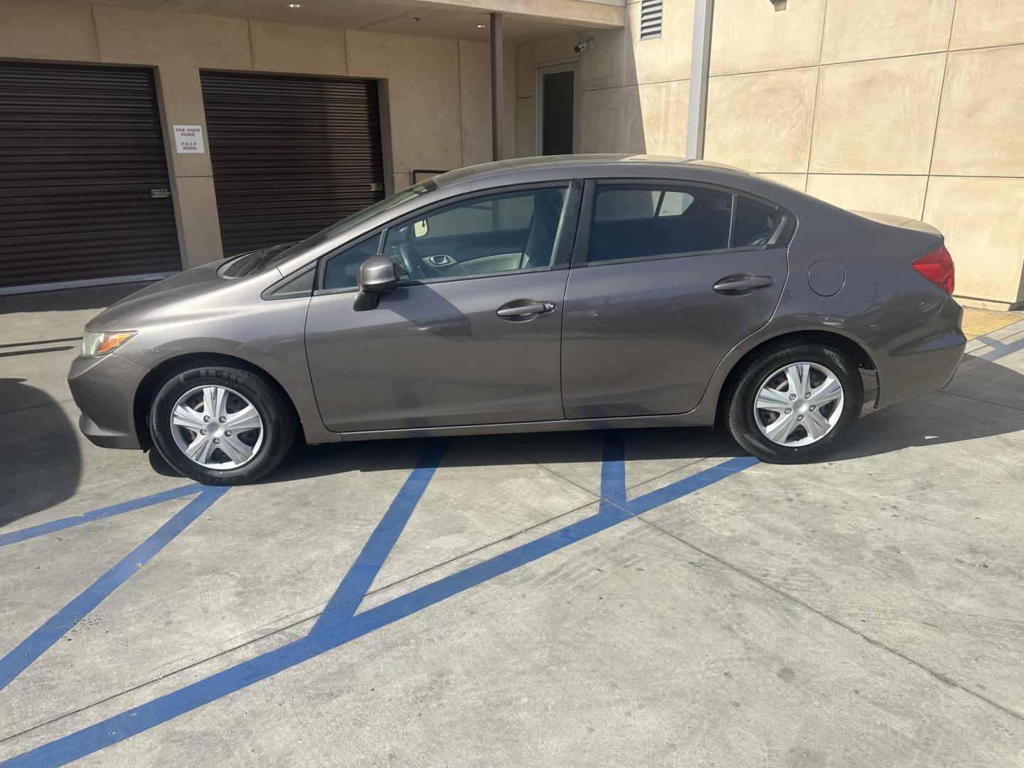 2012 Urban Titanium Metallic /Tan Honda Civic LX Sedan 5-Speed AT (19XFB2F59CE) with an 1.8L L4 SOHC 16V engine, 5-Speed Automatic transmission, located at 30 S. Berkeley Avenue, Pasadena, CA, 91107, (626) 248-7567, 34.145447, -118.109398 - This 2012 Honda Civic LX Sedan automatic looks and drives good. Bad credit, we can help. We are the bank. This Honda Civic LX comes with the following : Options A-C Adjustable Steering Wheel AM-FM Stereo Auxiliary Audio Input Brake Assist Bucket Seats CD Player Child Safet - Photo#3