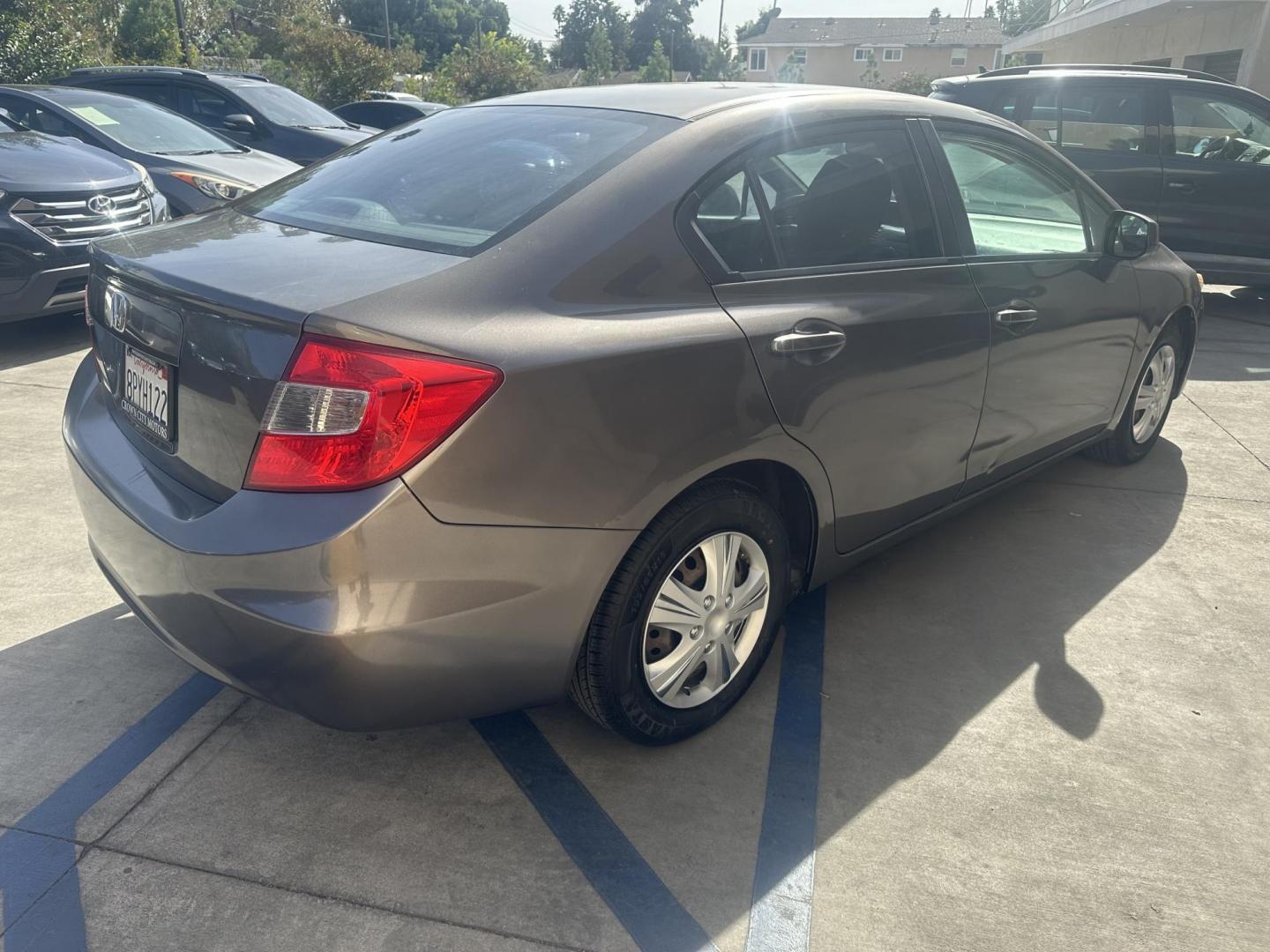 2012 Urban Titanium Metallic /Tan Honda Civic LX Sedan 5-Speed AT (19XFB2F59CE) with an 1.8L L4 SOHC 16V engine, 5-Speed Automatic transmission, located at 30 S. Berkeley Avenue, Pasadena, CA, 91107, (626) 248-7567, 34.145447, -118.109398 - This 2012 Honda Civic LX Sedan automatic looks and drives good. Bad credit, we can help. We are the bank. This Honda Civic LX comes with the following : Options A-C Adjustable Steering Wheel AM-FM Stereo Auxiliary Audio Input Brake Assist Bucket Seats CD Player Child Safet - Photo#5