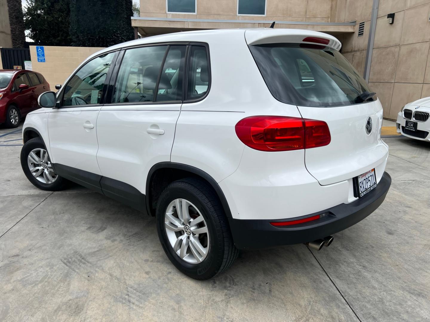 2014 White Volkswagen Tiguan S (WVGAV3AX0EW) with an 2.0L L4 DOHC 16V TURBO engine, AUTOMATIC transmission, located at 30 S. Berkeley Avenue, Pasadena, CA, 91107, (626) 248-7567, 34.145447, -118.109398 - Crown City Motors is a used “Buy Here Pay Here” car dealer in Pasadena CA. “Buy Here Pay Here” financing, means that when you purchase your vehicle from our dealership, that you make the payments to the dealership as well. We do not need the banks approval to get you approved for a used auto - Photo#2