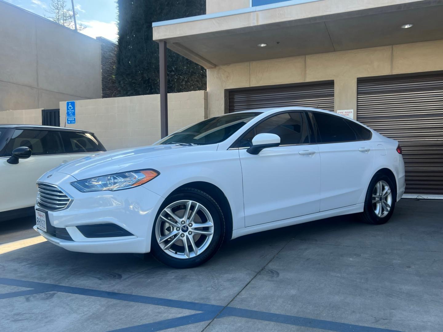 2018 White /Gray Ford Fusion SE (3FA6P0H72JR) with an 2.5L L4 DOHC 16V engine, AUTOMATIC transmission, located at 30 S. Berkeley Avenue, Pasadena, CA, 91107, (626) 248-7567, 34.145447, -118.109398 - Crown City Motors is a used “Buy Here Pay Here” car dealer in Pasadena CA. “Buy Here Pay Here” financing, means that when you purchase your vehicle from our dealership, that you make the payments to the dealership as well. We do not need the banks approval to get you approved for a used auto - Photo#0