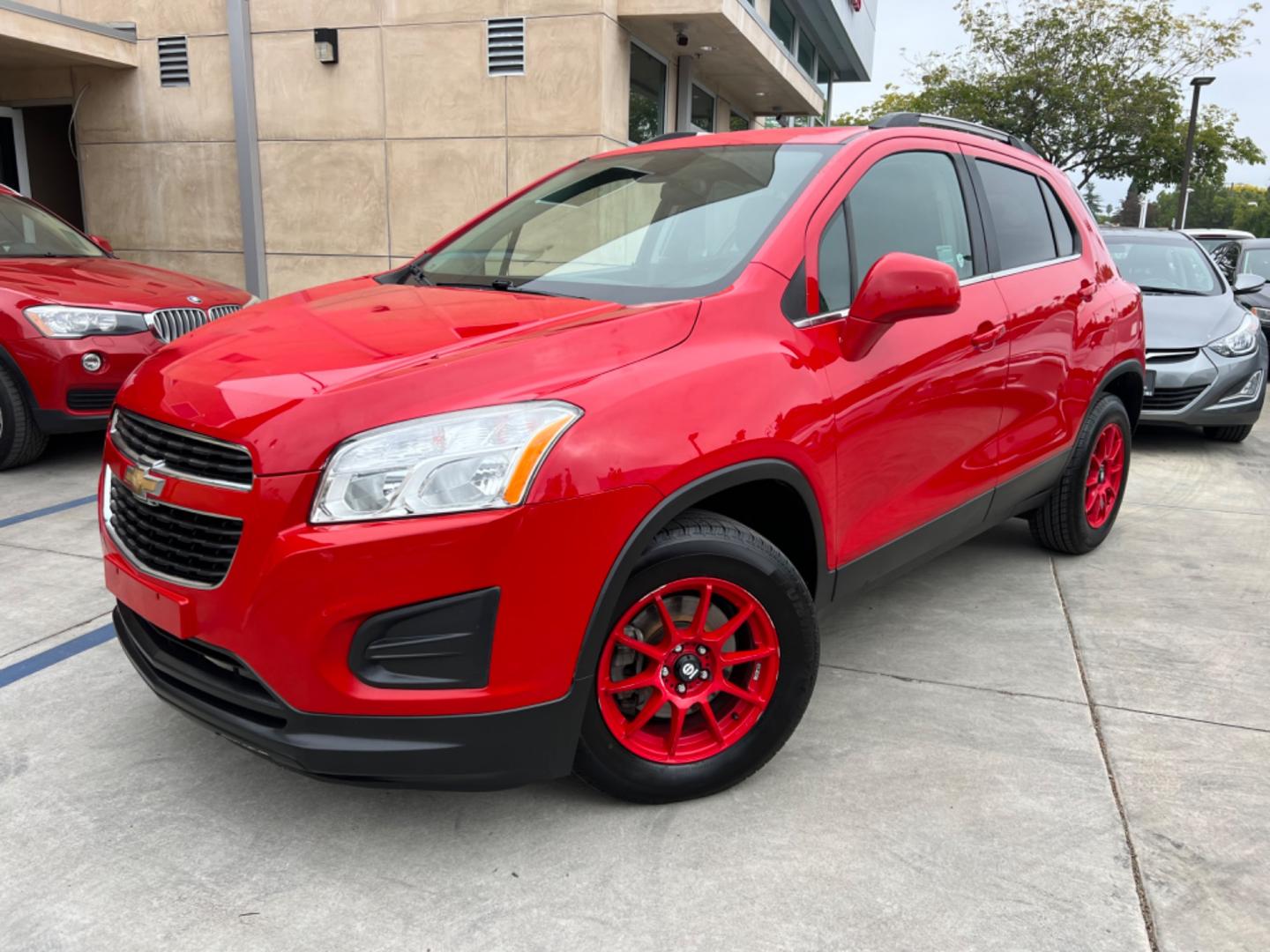 2015 RED /Black Chevrolet Trax LT AWD (KL7CJRSB2FB) with an 1.4L L4 DOHC 16V FFV engine, AUTOMATIC transmission, located at 30 S. Berkeley Avenue, Pasadena, CA, 91107, (626) 248-7567, 34.145447, -118.109398 - Crown City Motors is a used “Buy Here Pay Here” car dealer in Pasadena CA. “Buy Here Pay Here” financing, means that when you purchase your vehicle from our dealership, that you make the payments to the dealership as well. We do not need the banks approval to get you approved for a used auto - Photo#0