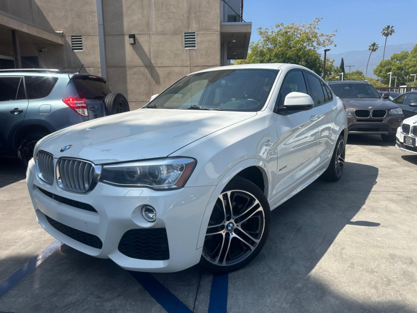 2015 Alpine White /Black BMW X4 Leather (5UXXW3C59F0) with an 2.0 engine, Automatic transmission, located at 30 S. Berkeley Avenue, Pasadena, CA, 91107, (626) 248-7567, 34.145447, -118.109398 - Discover the 2015 BMW X4 xDrive28i: Luxury Meets Affordability Are you in the market for a luxury vehicle that doesn't break the bank? Look no further than the 2015 BMW X4 xDrive28i. This impressive model offers the perfect blend of performance, style, and affordability. At our dealership, we under - Photo#0